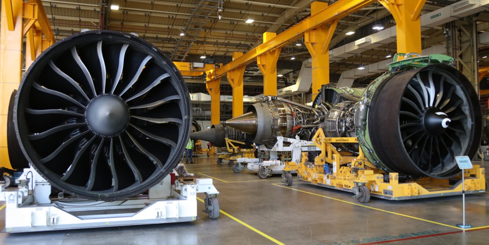 Aircraft engine stands supporting jet engines during assembly and maintenance.